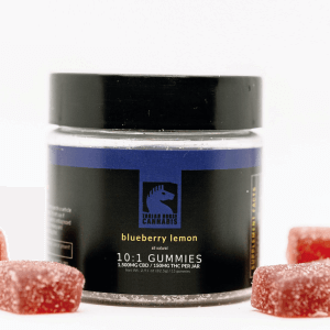 Small glass jar with black lid, black and navy label and 5 gummie cubes covered in sugar